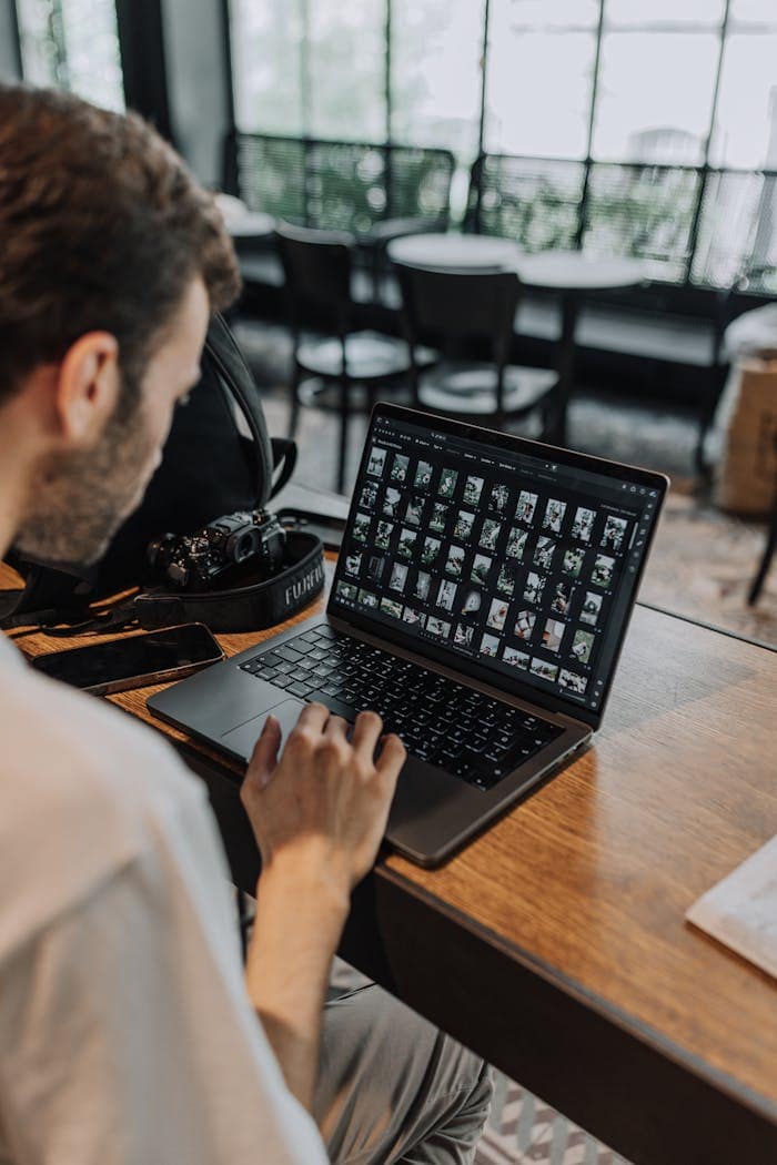 Man Using Laptop at Cafe